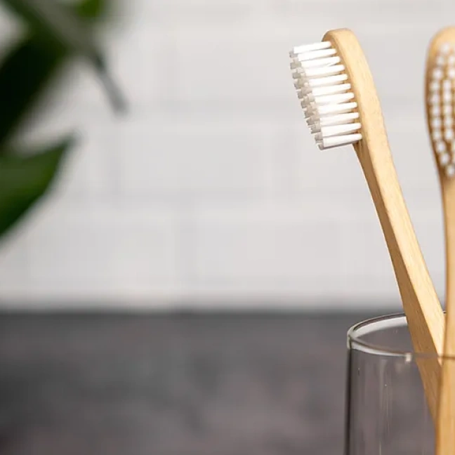Bamboo toothbrushes in a glass holder